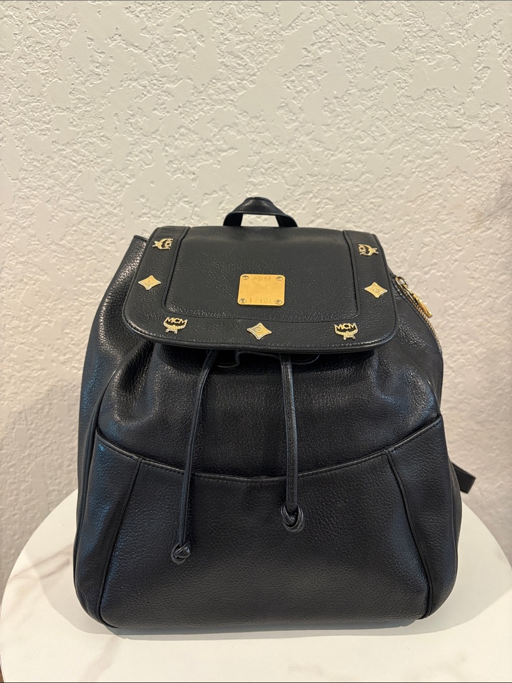 MCM Black Pebbled Leather Drawstring Backpack with Gold Accents